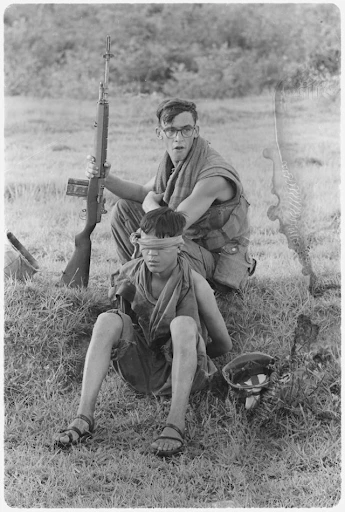 Corporal M.R. Carter guards an NVA soldier he captured during a ground movement (1968) Unknown Author | Wikimedia Commons