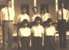 Johnson (left) and his students in front of a school building at Chakkhamkhanaton School | Friends of Thailand
