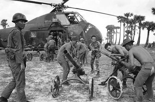 South Vietnamese soldiers prepare to load Chinese-made recoilless rifles aboard a waiting helicopter in Cambodia, 85 miles northeast of Phnom Penh, on May 25, 1970. The weapons were captured as the troops advanced down route seven toward the Chup rubber plantation. (May 25, 1970) | Nick Ut
