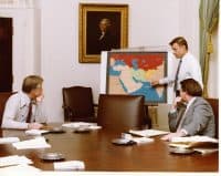 National Security Advisor Zbigniew Brzezinski pointing toward a map of Iran and countries in its vicinity during a meeting with President Carter and Frank Moore to brief them about the Iran hostage crisis on January 4, 1980