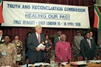 Archbishop Demond Tutu (Center), appointed as Deputy Chair of Truth and Reconciliation Commission, at the Commission’s first hearing (1996) Benny Gool—Oryx Media/Desmond Tutu Peace Centre