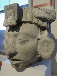 A stone sculpture of a head wearing a headdress from the ancient Mayan site of Copan in modern-day Honduras, found in the Mesoamerican collection at Harvard University’s Peabody Museum, which serves to exemplify the collections of ancient pre-Columbian art at museums in many art-importing countries, as well as the importance of engaging with art museums to protect cultural property