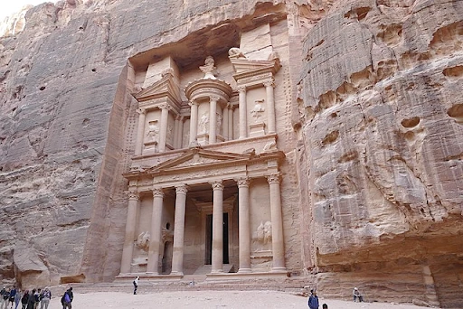 The Treasury, also known as the Al Khazneh, is located at Petra, a historical, archaeological site in Jordan. The Treasury is a pilgrimage site carved from a rose-looking sandstone; hence, the reason why the city is titled "the Rose City."