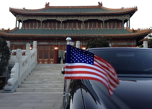 The American Flag Flutters on Car in Beijing, China (2013) U.S. Department of State | Wikimedia Commons