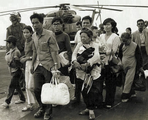 South Vietnamese refugees walk across a U.S. Navy vessel. Operation Frequent Wind, the final operation in Saigon, began April 29, 1975. During a nearly constant barrage of explosions, the Marines loaded American and Vietnamese civilians, who feared for their lives, onto helicopters that brought them to waiting aircraft carriers. The Navy vessels brought them to the Philippines and eventually to Camp Pendleton, Calif. U.S. Marines in Japan Homepage.