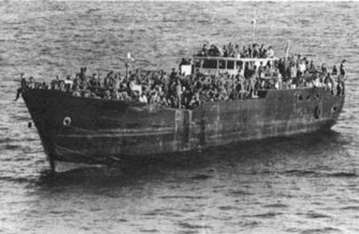 A Vietnamese coastal steamer loaded with refugees off Vung Tau, Vietnam, in late April 1975. This ship fired on the U.S. Military Sea Transportation Service ship USNS Sgt. Andrew Miller (T-AK-242) when it was unable to offload the refugees. The fire stopped after the guided missile destroyer USS Henry B. Wilson (DDG-7) trained its 127 mm guns on the ship. 1975, U.S. Navy, Navysite.de 