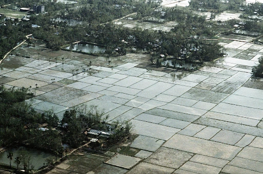 An aerial view of flooded fields in the aftermath of a cyclone which struck the area on April 30 (1991) A1C Cheryl Sanzi | U.S. National Archives