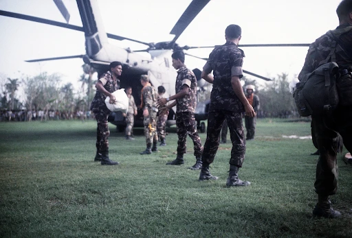 Bangladesh and U.S. military personnel unload supplies from a CH-53 Sea Stallion helicopter during Operation Sea Angel (1991) A1C Cheryl Sanzi | U.S. National Archives