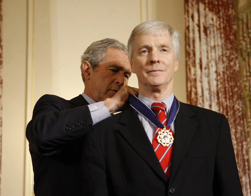 President George W. Bush places the Presidential Medal of Freedom to U.S. Ambassador to Iraq Ryan Crocker during a ceremony Thursday, Jan. 15, 2009, at the U.S. Department of State to commemorate foreign policy achievements. White House photo by Eric Drape