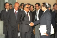 Palestinian delegation in Madrid, Elyakim Rubinstein, shakes hands with his Arab counterpart. Ya'acov Sa'ar, Israeli Government Press Office