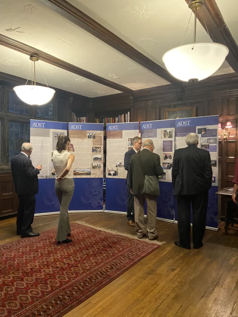 Attendees at an event to mark the 100th anniversary of the U.S. Foreign Service study the mobile exhibit on display in the library of the International Student House of Washington DC on October 29, 2024. Photo by Ninya Khabush.