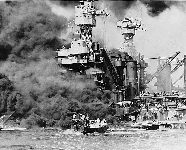 A small boat rescues a seaman from the smoking USS West Virginia. Library of Congress Prints & Photographs Division