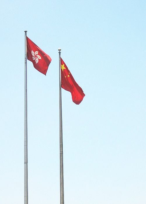 Flag of Hong Kong alongside the flag of China. Simon Shek