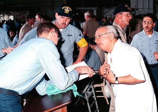 An evacuee from Freetown, Sierra Leone, is processed after arriving onboard the USS Kearsarge (LHD 3), on May 30, 1997, during Operation Noble Obelisk. 